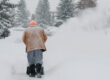 man pushing a snow blower