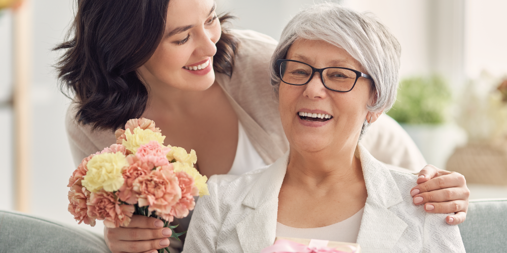 Senior mother receiving a gift from her daughter
