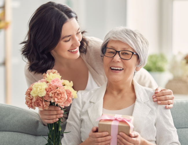 Senior mother receiving a gift from her daughter