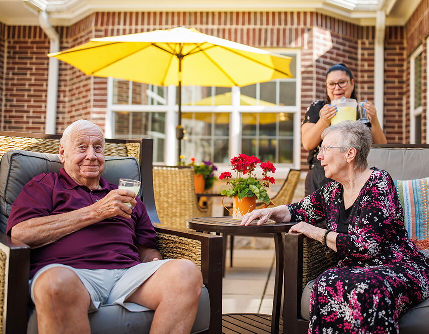 Male and Female resident enjoying lemonade on the courtyard