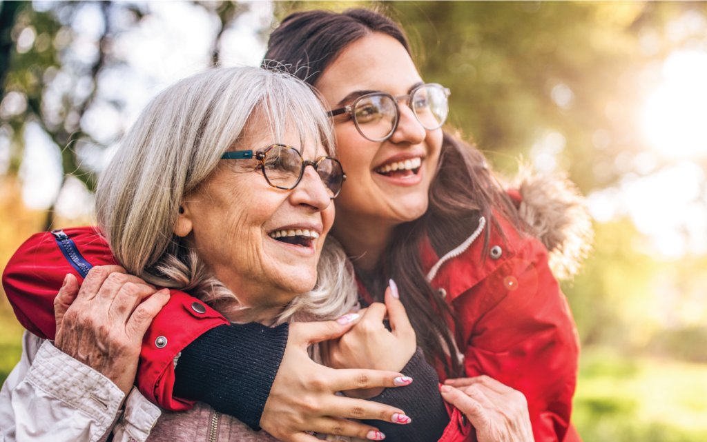 Grandmother and Granddaughter smiling and looking into the distance