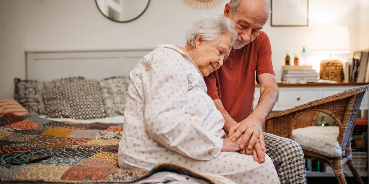 Senior couple sitting on a bed