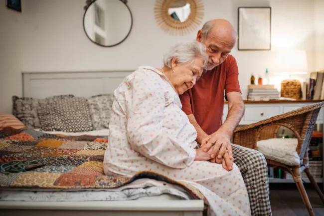 Senior couple sitting on a bed Senior couple sitting on a bed